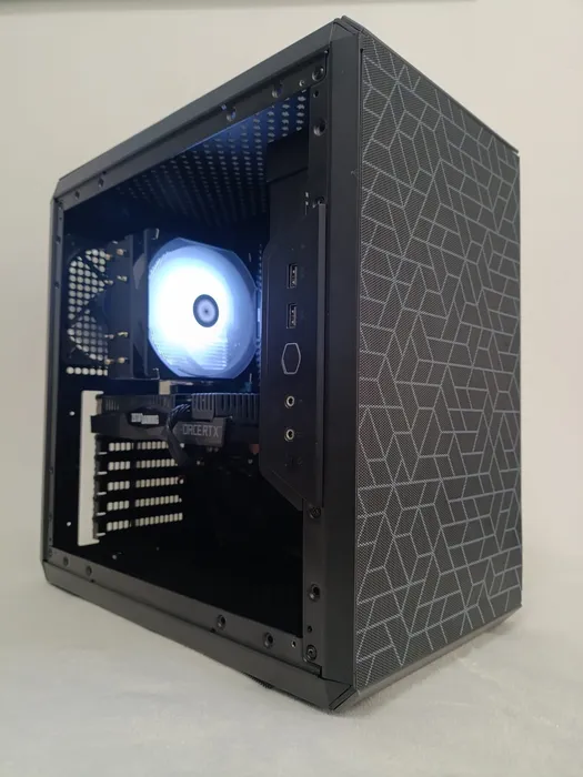 Black desktop with a geometric front panel and blue-lit processor fan